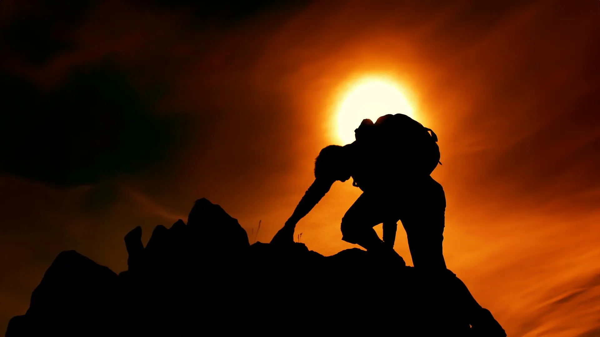 A man climbing up a mountain to signify AerynOS overcoming it’s challenges